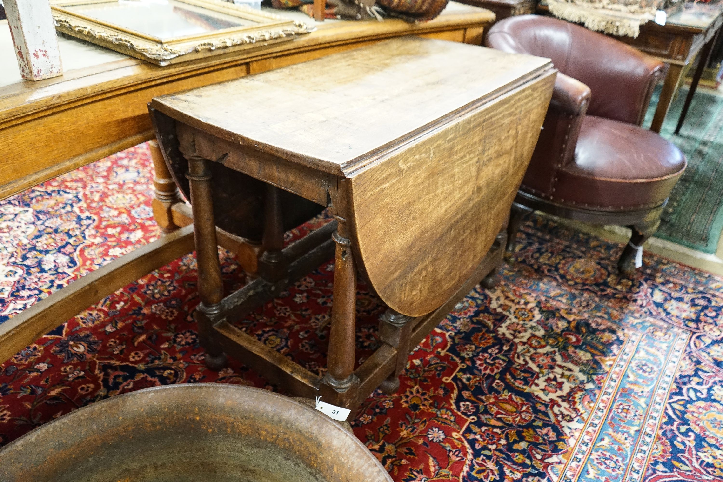 An 18th century style oak gateleg dining table, length 148cm extended, width 105cm, height 76cm